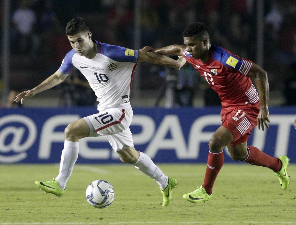United States' Christian Pulisic, left, fight for the ball with Panama's Luis Ovalle during a a 2018 World Cup qualifying soccer match in Panama City, Tuesday, March 28, 2017. (AP Photo/Arnulfo Franco)