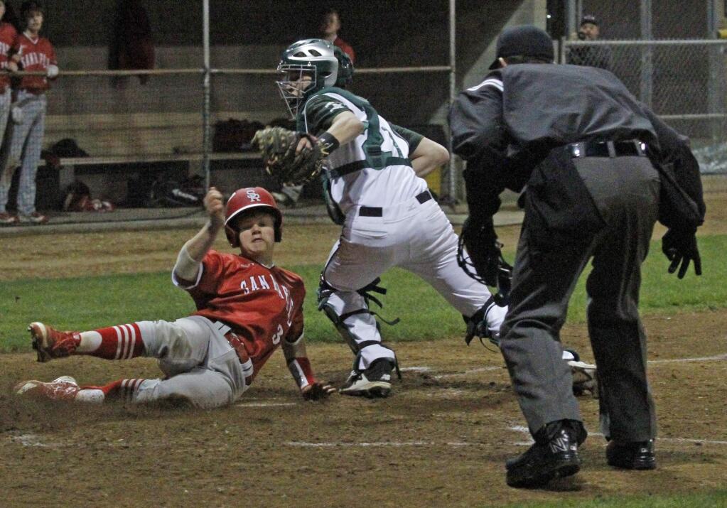 Bill Hoban/Index-TribuneSonoma catcher Colton Mertens looks for a sign from the umpire during a play at the plate in Friday night's game against San Rafael. The runner was safe, but the Dragon ended up bearing San Rafael 11-6.
