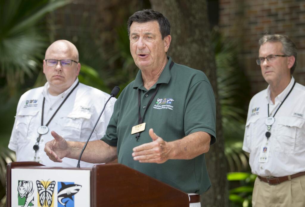 Ron Forman, center, President and CEO of the Audubon Nature Institute, speaks during a press conference at the Audubon Zoo, Saturday, July 14, 2018 in New Orleans. The Audubon Zoo closed Saturday after a jaguar escaped from its habitat and killed six animals, according to a release from zoo officials. (Brett Duke/The Times-Picayune via AP)
