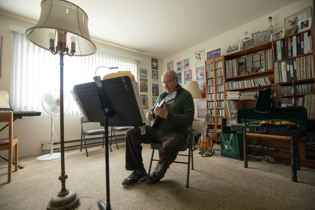 Sonoma County musician Gus Garelick  has been busking and gigging in Sonoma County for nearly 40 years, rehearses in his Santa Rosa apartment December 28, 2022. (Chad Surmick / The Press Democrat)