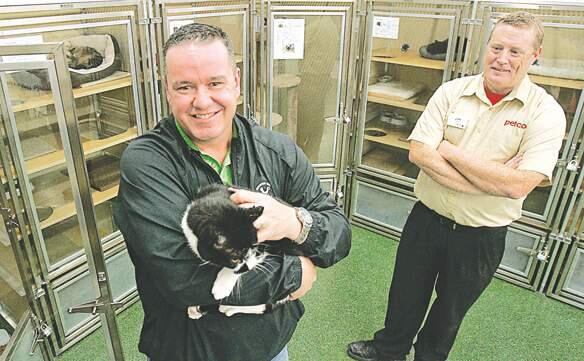 Jeff Charter, Executive Director of Petaluma Animal Services holds an adoptable cat from one of the new housing units at Petco as Jim White, Manager of Petco looks on. The new units are each 5 levels and are almost 18sq feet of space compared to the old ones at 3.5 sq ft.