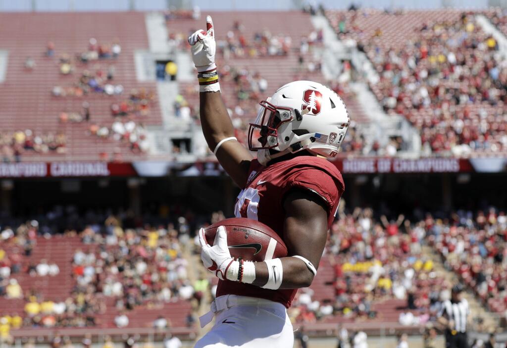 Stanford running back Bryce Love celebrates after scoring on a rushing touchdown against Arizona State during the first quarter of an NCAA college football game Saturday, Sept. 30, 2017, in Stanford, Calif. (AP Photo/Marcio Jose Sanchez)
