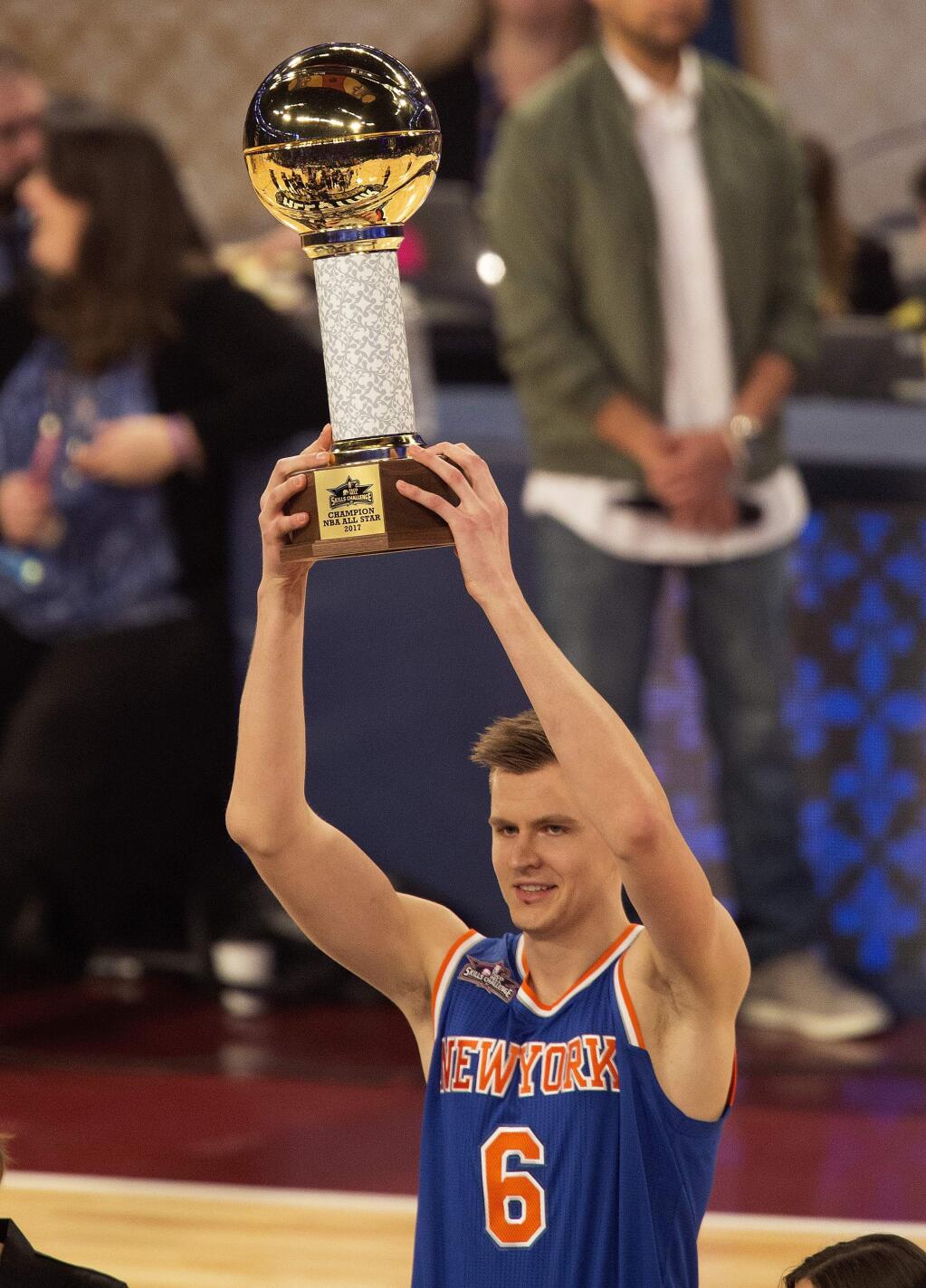 New York Knicks forward Kristaps Porzingis raises the trophy after winning the NBA Skills Challenge during the NBA All-Star Saturday Night events in New Orleans, Saturday, Feb. 18, 2017. (AP Photo/Max Becherer)