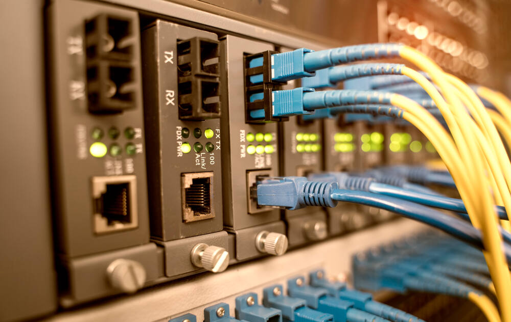 Fiber optical cables connected to optic ports and UTP Network cables connected to ethernet ports.