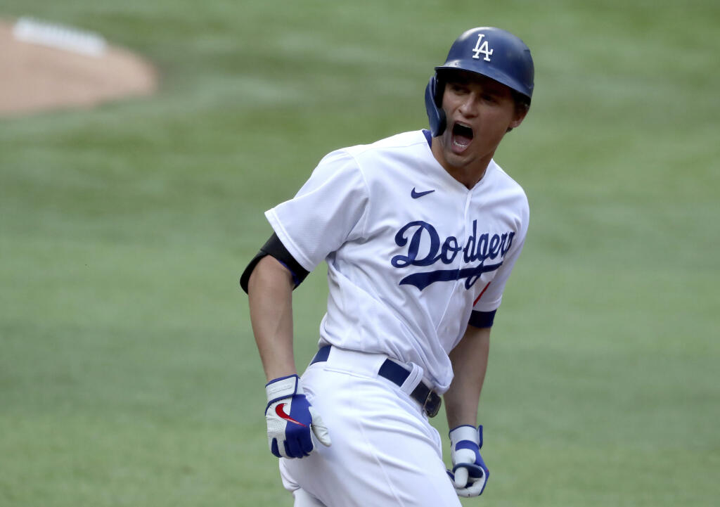 The Los Angeles Dodgers’ Corey Seager reacts after hitting a solo home run against the Atlanta Braves during the first inning in Game 6 of the National League Championship Series, Saturday, Oct. 17, 2020, in Arlington, Texas. (Curtis Compton / Atlanta Journal-Constitution)