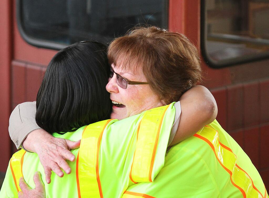 Dawnette Reed, left, receives a hug from Marsha Brandhorst after finishing her final shift as a toll collector at the Golden Gate Bridge on Tuesday, March 27, 2013. (CONNER JAY/ PD FILE)
