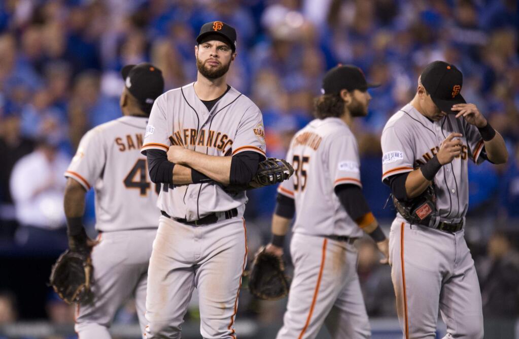 San Francisco Giants first baseman Brandon Belt and his teammates wait during a pitching change in the sixth inning against the Kansas City Royals during Game 2 of baseball's World Series, Wednesday, Oct. 22, 2014, in Kansas City, Mo. (AP Photo/The Sacramento Bee, Paul Kitagaki Jr.)