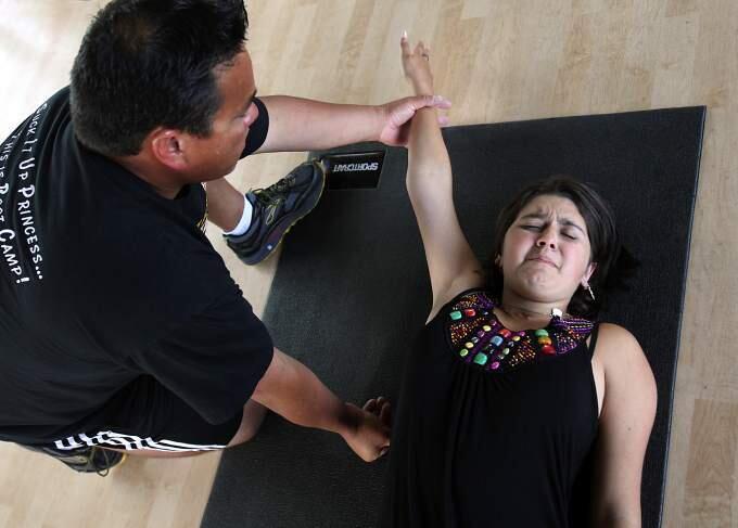 Personal trainer Jayme Larson works with Julia Bertoli, who suffered brain damage and other injuries after she was hit by a car while walking in a Sebastopol crosswalk in 2009. (JOHN BURGESS/ PD FILE, 2010)