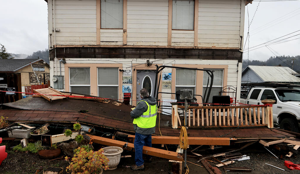 Kevin Caldwell, the Rio Dell building inspector, red tags a home Tuesday, Dec. 20, in Rio Dell after a magnitude 6.4 earthquake rumbled through Humboldt County. (Kent Porter/The Press Democrat)