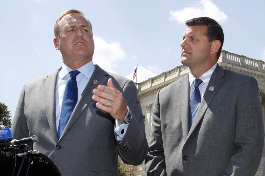 FILE - In this Wednesday, May 9, 2018 file photo, Rep. Jeff Denham, R-Calif., left, speaks next to Rep. David Valadao, R-Calif., during a news conference on Capitol Hill in Washington. The Republican incumbents were swept out of office in 2018 after a tally of late-arriving ballots. (AP Photo/Jacquelyn Martin)
