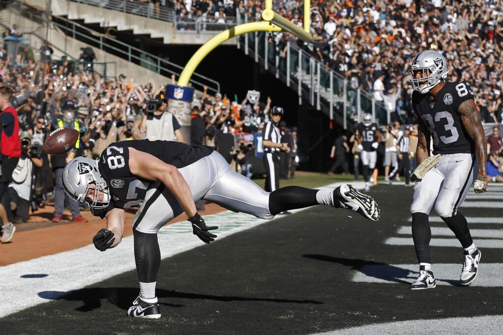 Oakland Raiders tight end Foster Moreau, left, celebrates after scoring a touchdown as tight end Darren Waller looks on during the first half against the Cincinnati Bengals in Oakland, Sunday, Nov. 17, 2019. (AP Photo/D. Ross Cameron)