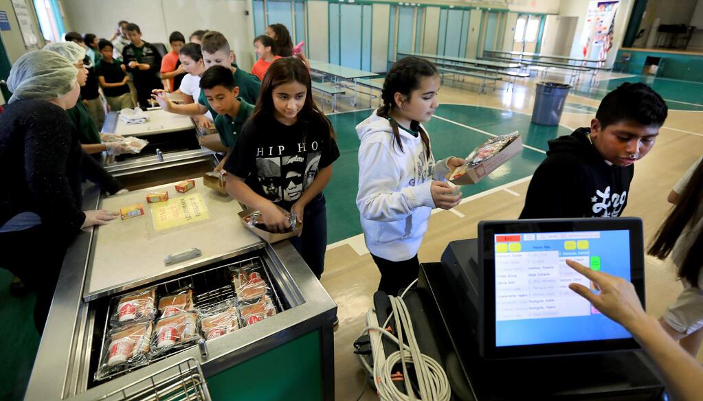 Sixth graders at Luther Burbank Elementary School in Santa Rosa, receive their hot lunches, Monday Sept. 25, 2017. (Kent Porter / The Press Democrat)