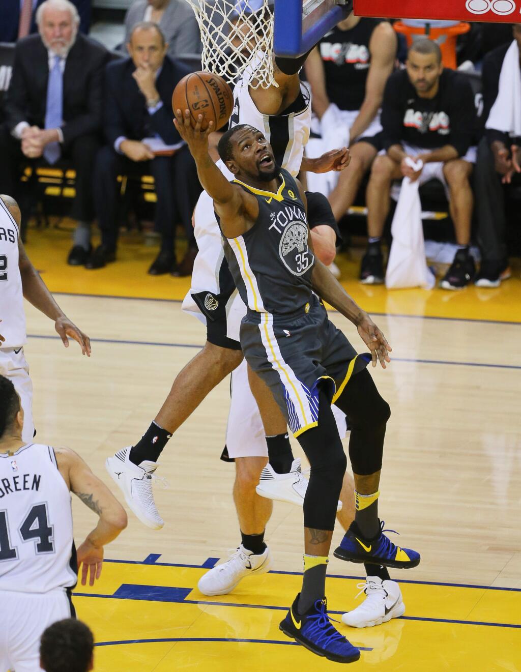 Golden State Warriors forward Kevin Durant scores on a layup against the San Antonio Spurs, during their game in Oakland on Monday, April 16, 2018. (Christopher Chung/ The Press Democrat)