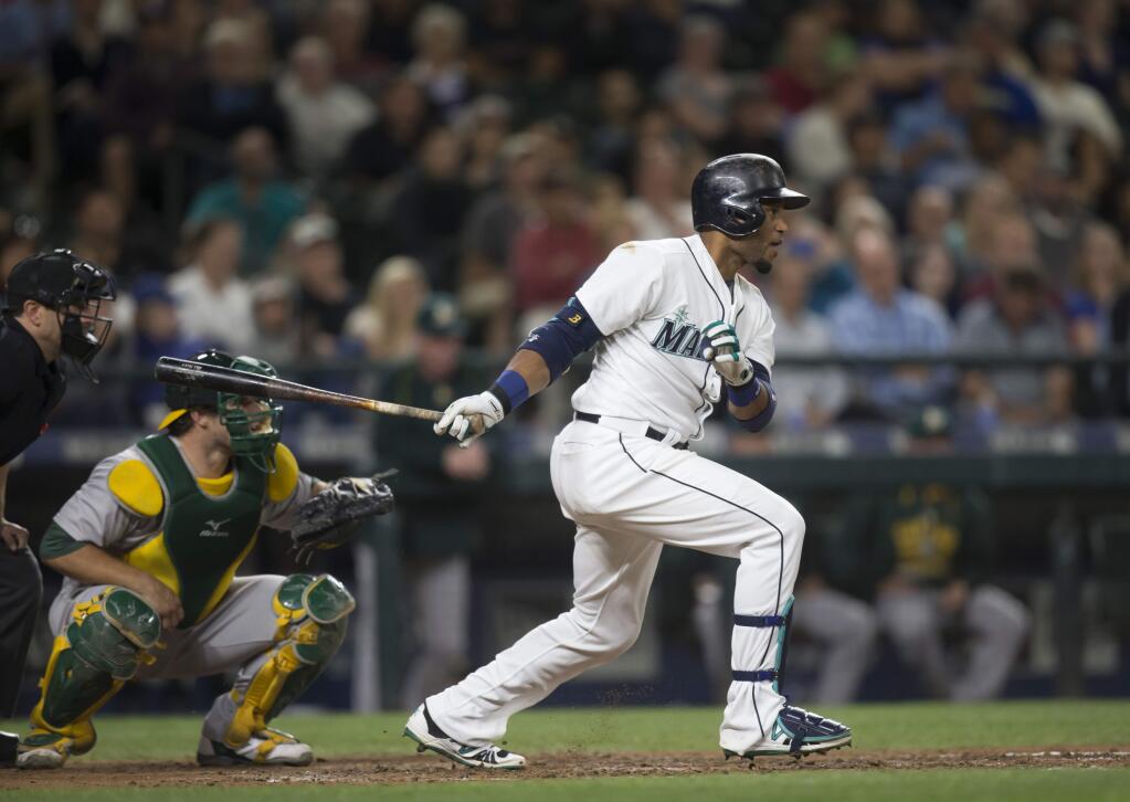 Seattle Mariners' Robinson Cano follows through on an RBI single during the fifth inning of a baseball game against the Oakland Athletics, Tuesday, Aug. 25, 2015, in Seattle. (AP Photo/Stephen Brashear)
