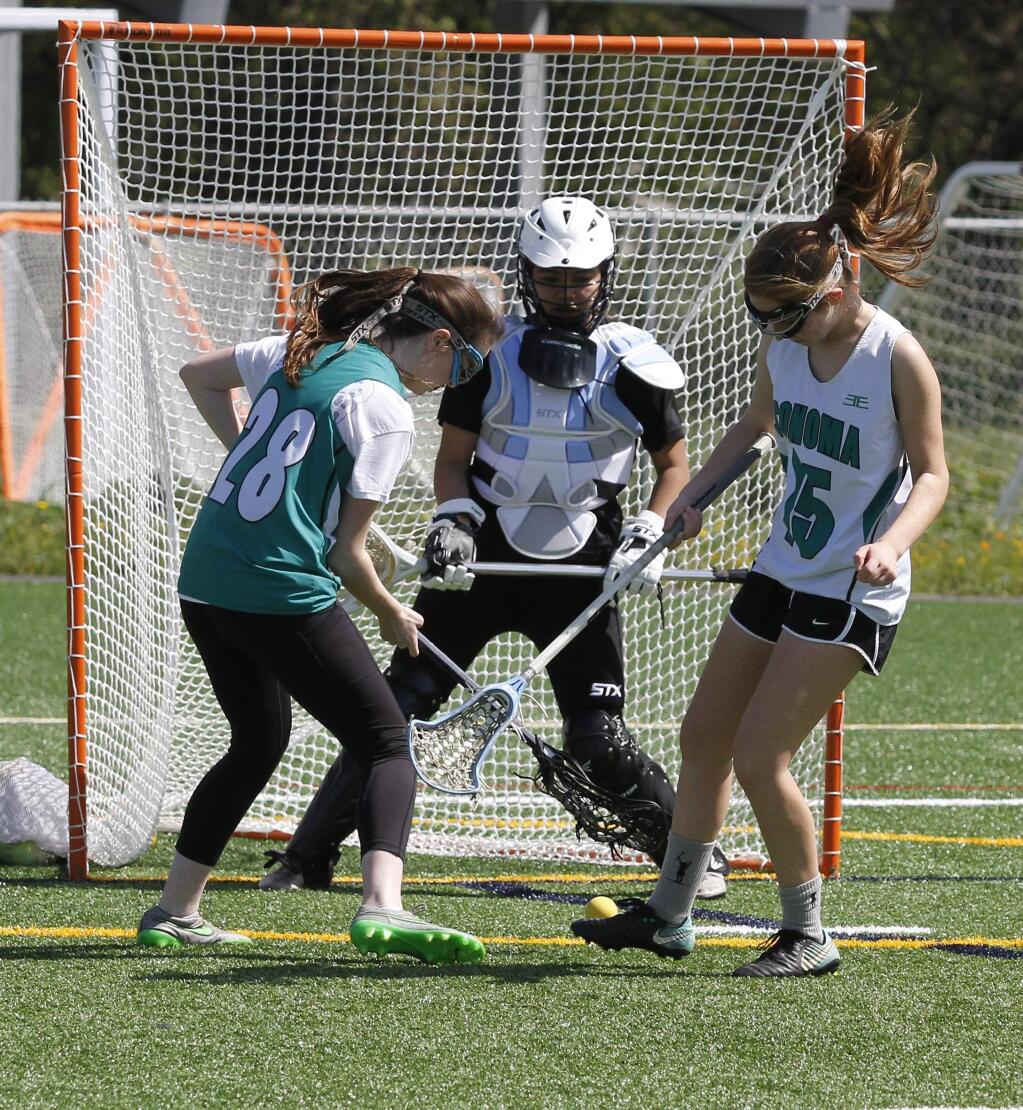 Bill Hoban/Index-TribuneGetting some extra practiceWhile goalie Lisette Aguilar watches, Mary Gallo (28) and Reese Dobson (15) try to corral a loose ball. The girls are members of the Petaluma-Sonoma Thunder, a high school club lacrosse team. The team had a scrimmage scheduled for Sunday morning as part of a lacrosse day at the new multi-purpose field behind Adele Harrison Middle School. The team they were supposed to scrimmage canceled on Saturday, so the girls used the time for some additional practice. In addition, there was a lacrosse clinic and some games featuring 8U and 10U teams.