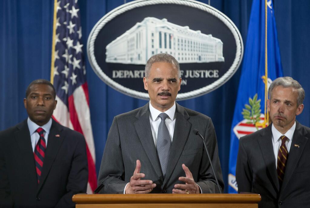 Attorney General Eric Holder, center, with Tony West, Justice Department's lead negotiator, left, and Colorado US Attorney John Walsh, right, announces at the Justice Department in Washington Monday, July 14, 2014, that Citigroup will pay $7 billion to settle an investigation into risky subprime mortgages, the type that helped fuel the financial crisis. The agreement comes weeks after talks between the sides broke down, prompting the government to warn that it would sue the New York investment bank. The bank had offered to pay less then $4 billion, a sum substantially less that what the Justice Department was asking for. The settlement stems from the sale of securities made up of subprime mortgages, which fueled both the housing boon and bust that triggered the Great Recession at the end of 2007. (AP Photo/Pablo Martinez Monsivais)
