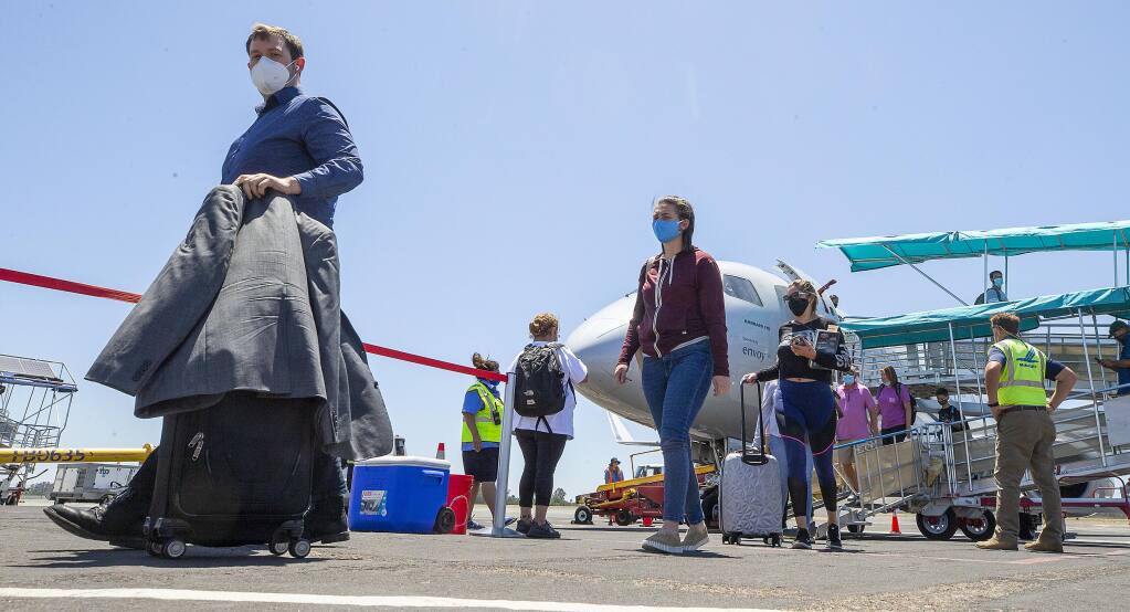 Passengers from Dallas/Fort Worth arrive on an American Airlines’ flight to Charles M. Schulz-Sonoma County Airport, on Wednesday, July 8, 2020. (John Burgess / The Press Democrat)