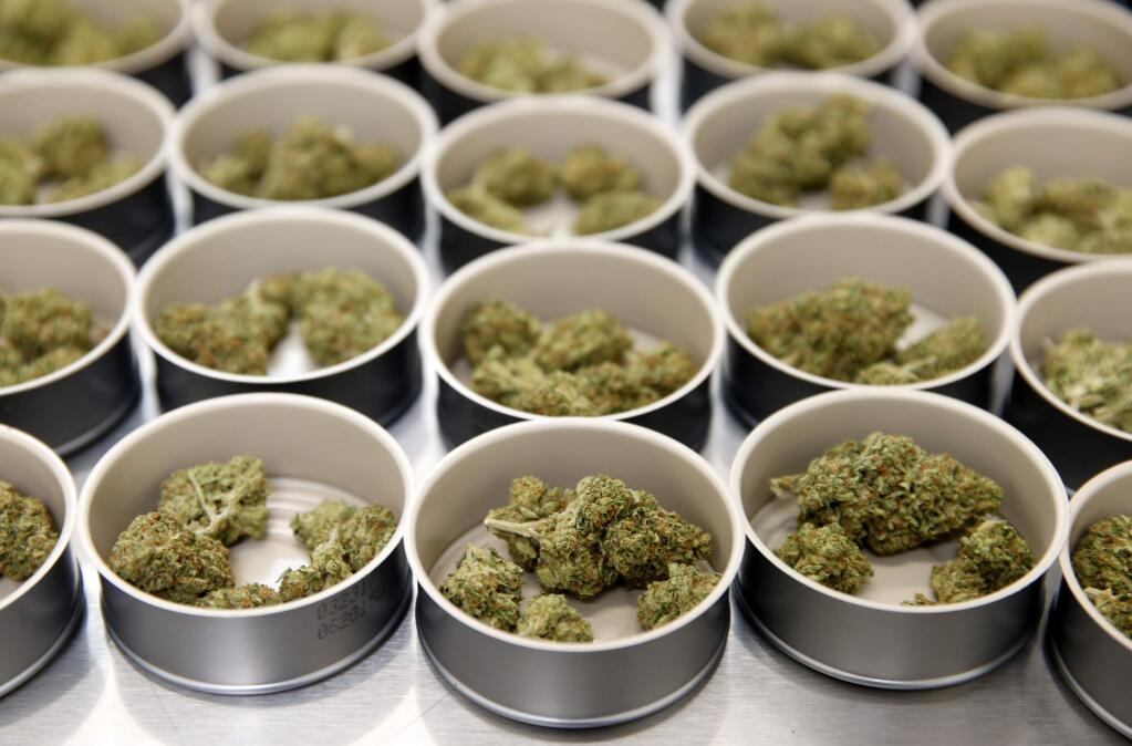 Tins of marijuana sit ready to be sealed in the packaging room at Mercy Wellness cannabis dispensary in Cotati, on Thursday, December 28, 2017. (BETH SCHLANKER/ The Press Democrat)