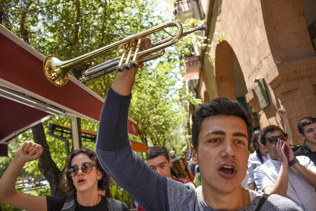Protesters shout anti-government slogans as march in Yerevan, Armenia, Wednesday, April 25, 2018. Several thousand protesters took to the streets of the Armenian capital on Wednesday morning after talks between the opposition and the acting prime minister were called off. (Narek Aleksanyan, PAN Photo via AP)