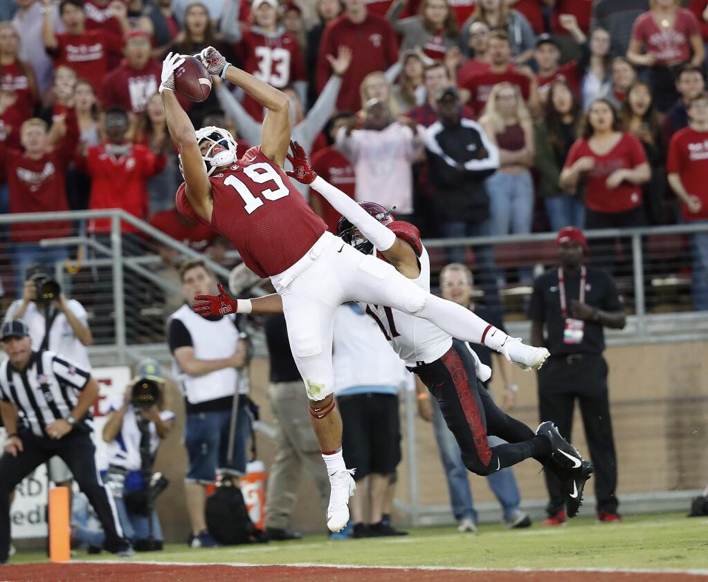 In this Friday, Aug. 31, 2018, file photo, Stanford wide receiver JJ Arcega-Whiteside catches a touchdown pass against San Diego State cornerback Ron Smith during the first half in Stanford. (AP Photo/Tony Avelar, File)