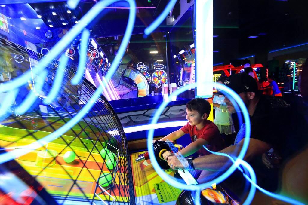 Ethan Simon, 4, plays a game with his dad Joe in the Game On Arcade at Epicenter Sports & Entertainment Center in Santa Rosa. (John Burgess/The Press Democrat)