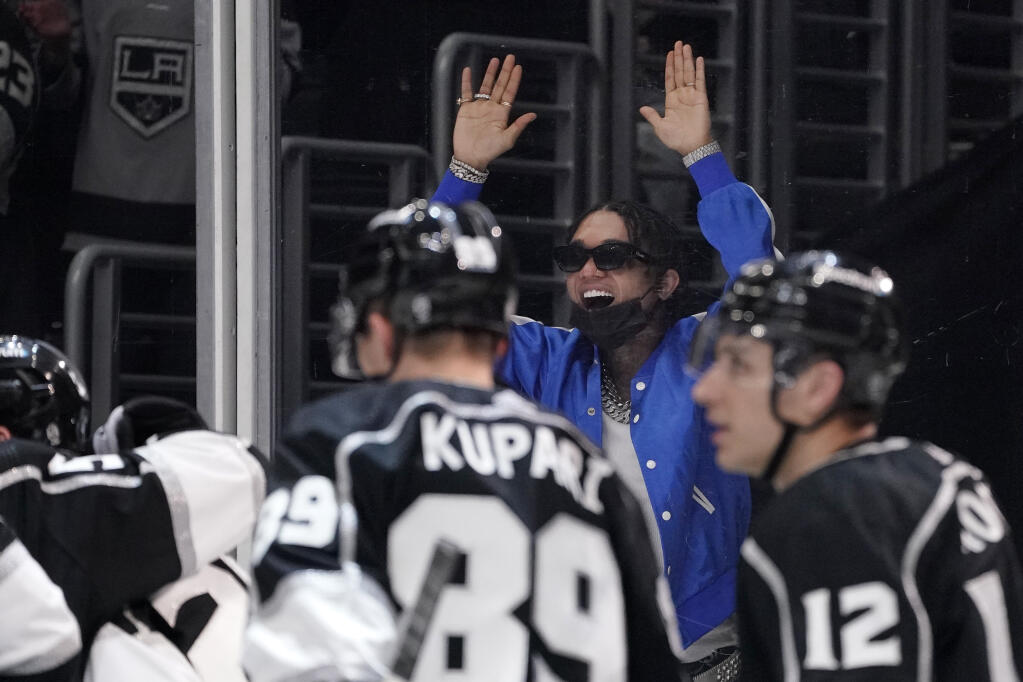 Entertainer Swae Lee celebrates after Los Angeles Kings right wing Arthur Kaliyev scored a goal during the second period of an NHL hockey game against the Tampa Bay Lightning Tuesday, Jan. 18, 2022, in Los Angeles. (AP Photo/Mark J. Terrill)