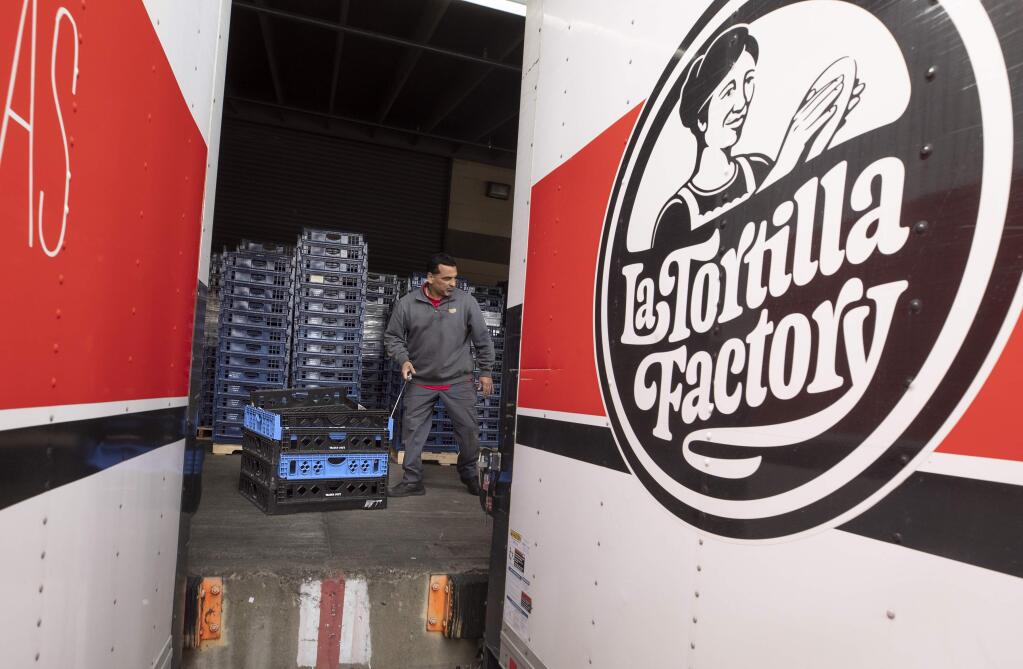 Paul Maytorena unloads his truck at the La Tortilla Factory warehouse in Santa Rosa on Friday, March 27, 2020. La Tortilla Factory is hiring drivers and production workers. (photo by John Burgess/The Press Democrat)