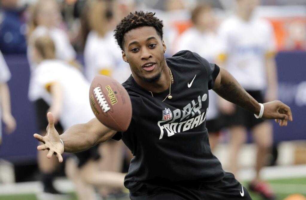 NFL Draft prospect Ohio State's Denzel Ward reaches to catch a football during a Play Football Clinic Wednesday, April 25, 2018, in Arlington, Texas. The 2018 NFL Draft begins Thursday, April 26, 2018, at AT&T Stadium. (AP Photo/David J. Phillip)