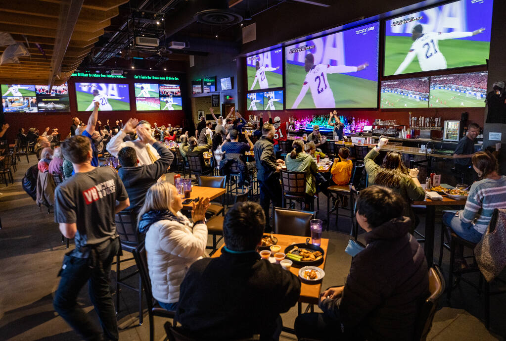 Soccer fans celebrate a U.S. goal in the first half against Wales in the first round of the World Cup at the Victory House in Epicenter Santa Rosa on Monday, November 21, 2022. (John Burgess/The Press Democrat)