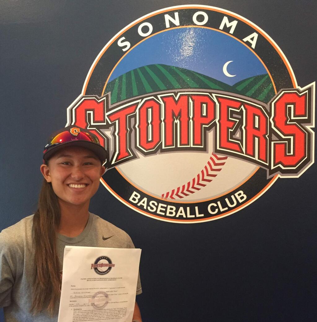 Submitted photoKelsey Whitmore holds her contract with the Stompers. Whitmore and Stacy Piagno will make history tonight being the first women to play for a professional baseball team.