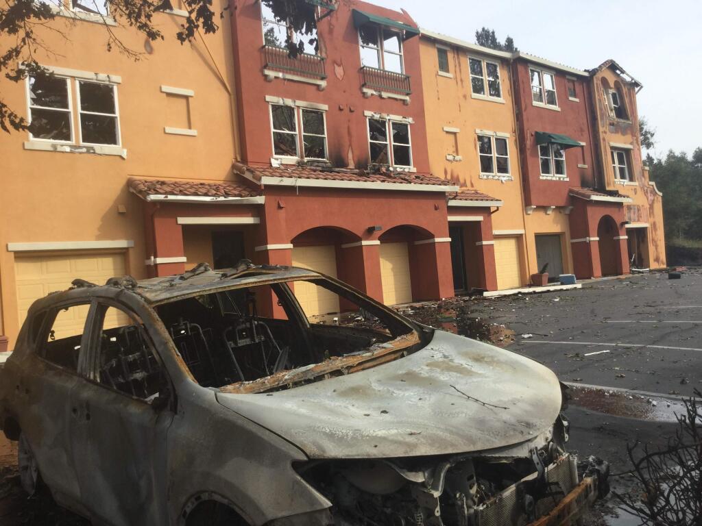 Chris smith / the press democrat A burned car sits in front of a row of scorched units at the Overlook apartments near the Home Depot off Mendocino Avenue.