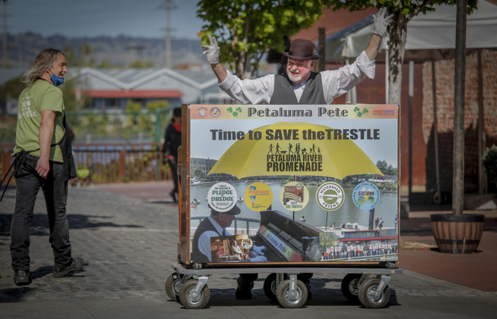 John Maher, aka Petaluma Pete, sets up his piano and performs for passersby on Petaluma Boulevard, near the trestle Tuesday, May 3, 2022. He hopes to bring attention to the need to fix up the 100-year-old structure. (CRISSY PASCUAL/ARGUS-COURIER STAFF)