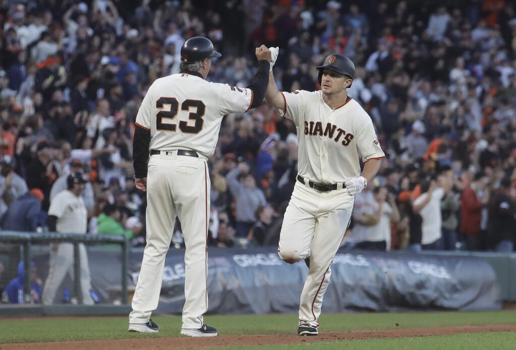 The San Francisco Giants' Alex Dickerson, right, is congratulated by third base coach Ron Wotus after hitting a solo home run against the Chicago Cubs during the fourth inning n San Francisco, Tuesday, July 23, 2019. (AP Photo/Jeff Chiu)