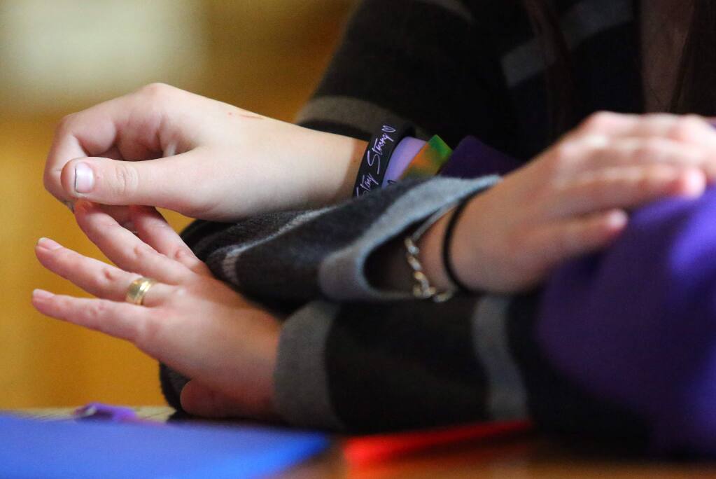 Program director Emily Mann holds the hand of a child in foster care at The Children's Village, in Santa Rosa on Thursday, February 27, 2014. (Christopher Chung/ The Press Democrat)