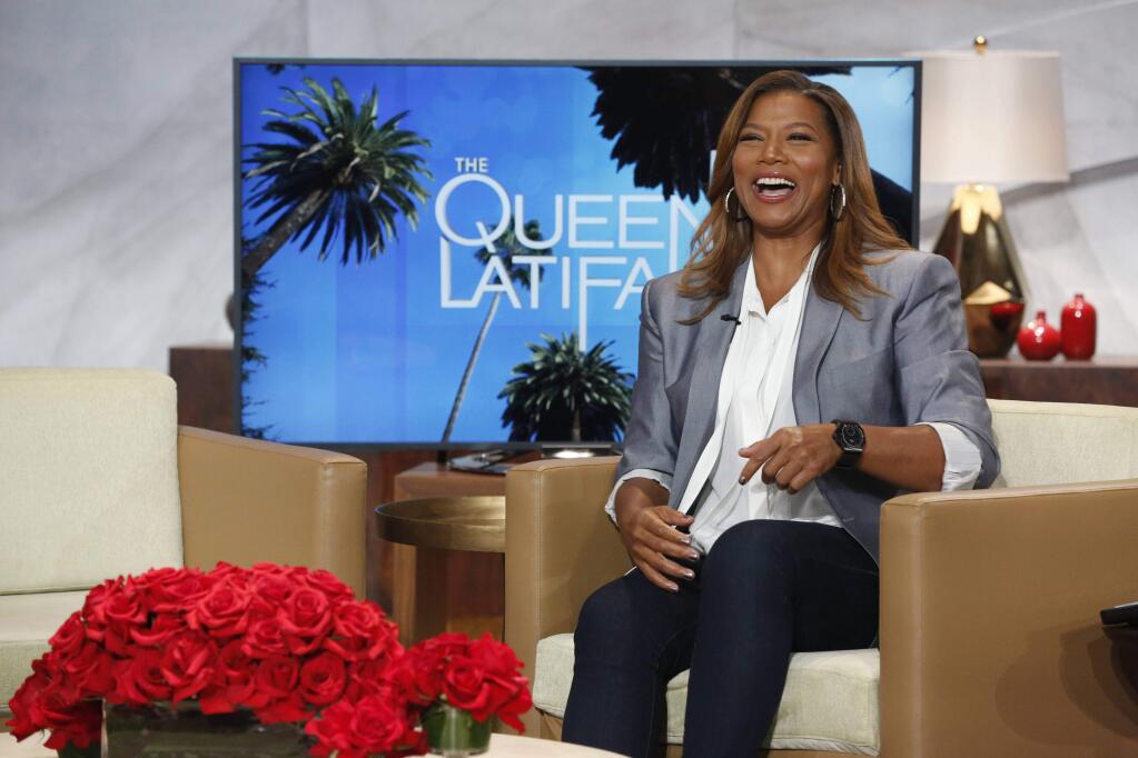 In this undated photo provided by Sony Pictures Television, talk show host, Queen Latifah, laughs on the set of 'The Queen Latifah Show,' in Culver City, Calif. (AP Photo/Sony Pictures Television)