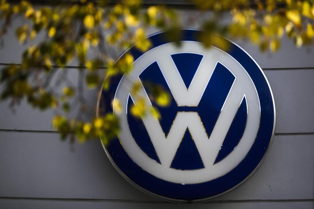 FILE - In this Oct. 5, 2015, file photo, the VW sign of Germany's Volkswagen car company is displayed at the building of a company's retailer in Berlin. A member of Volkswagen's supervisory board is calling for a quick solution to a legal dispute between the automaker and two suppliers that has forced VW to suspend production of some models at German plants, affecting nearly 28,000 workers. (AP Photo/Markus Schreiber, File)