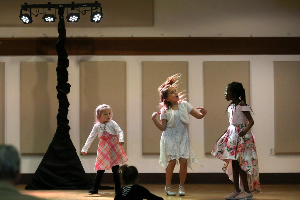 Giavanna Dewald, 3, left, her sister Isabella Wall, 8, center, and Renee Cole, 7, dance to music during the 'I Heart Rohnert Park' event at the Community Center in Rohnert Park, California on Sunday, February 10, 2019 . (BETH SCHLANKER/The Press Democrat)