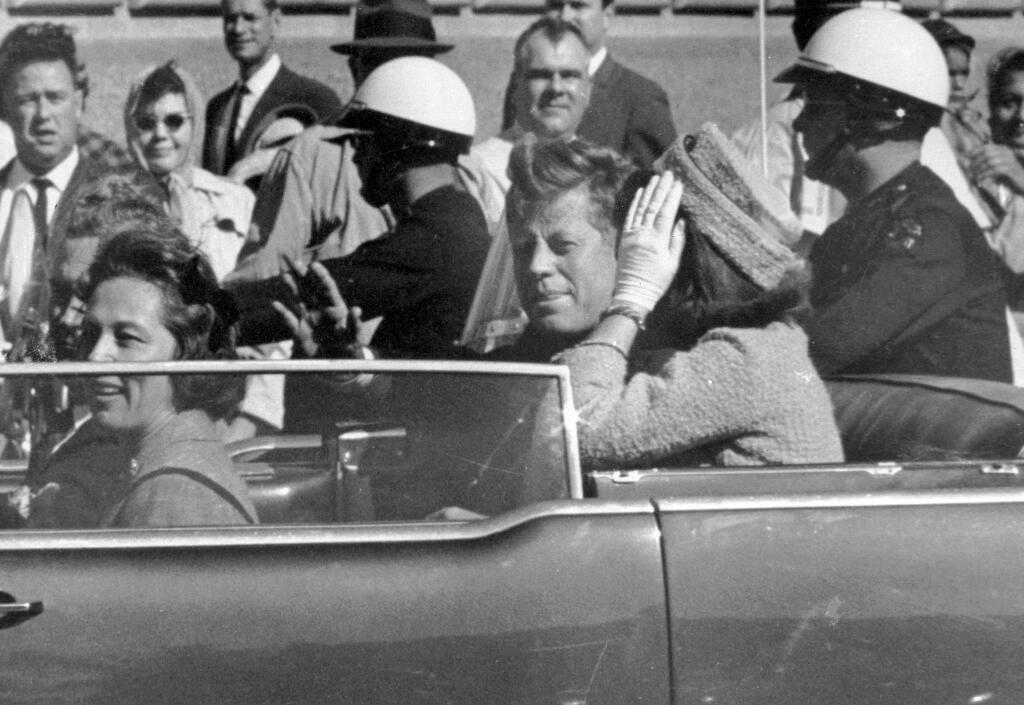 FILE - In this Nov. 22, 1963 file photo, President John F. Kennedy waves from his car in a motorcade in Dallas. Riding with Kennedy are First Lady Jacqueline Kennedy, right, Nellie Connally, second from left, and her husband, Texas Gov. John Connally, far left. President Donald Trump, on Saturday, Oct. 21, 2017, says he plans to release thousands of never-seen government documents related to President John F. Kennedy's assassination. (AP Photo/Jim Altgens, File)