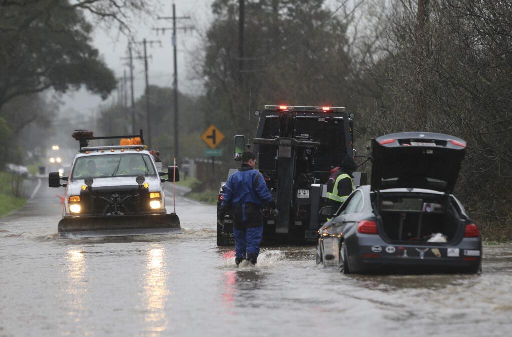 A vehicle is stuck in water at Skillman Lane in Petaluma on Wednesday, Feb. 13, 2019. (Beth Schlanker / The Press Democrat)