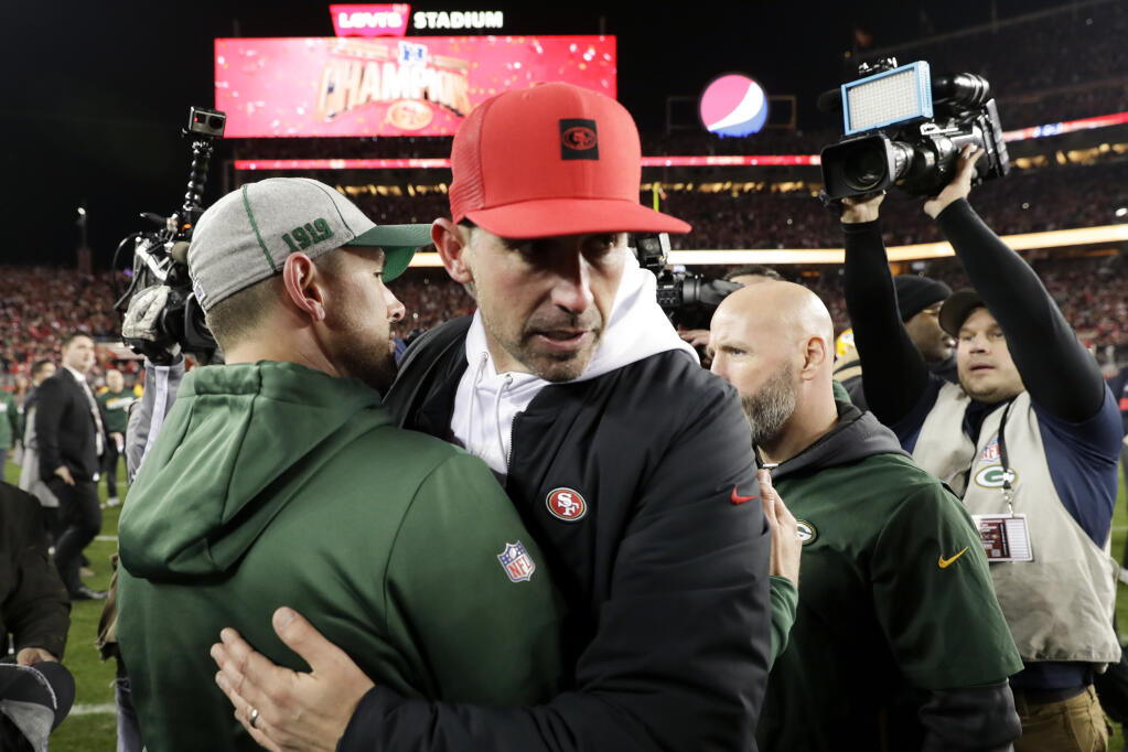 San Francisco 49ers head coach Kyle Shanahan, right, hugs Green Bay Packers head coach Matt LaFleur after the 49ers won the NFC championship game on Sunday, Jan. 19, 2020, in Santa Clara. (Matt York / ASSOCIATED PRESS)