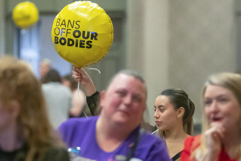 Sarah Gonzalez of Louisville, Ky., holds a balloon at Protect Kentucky Access' election watch party at the Galt House in Louisville, Ky., Tuesday, Nov. 8, 2022. (Ryan C. Hermens/Lexington Herald-Leader via AP)