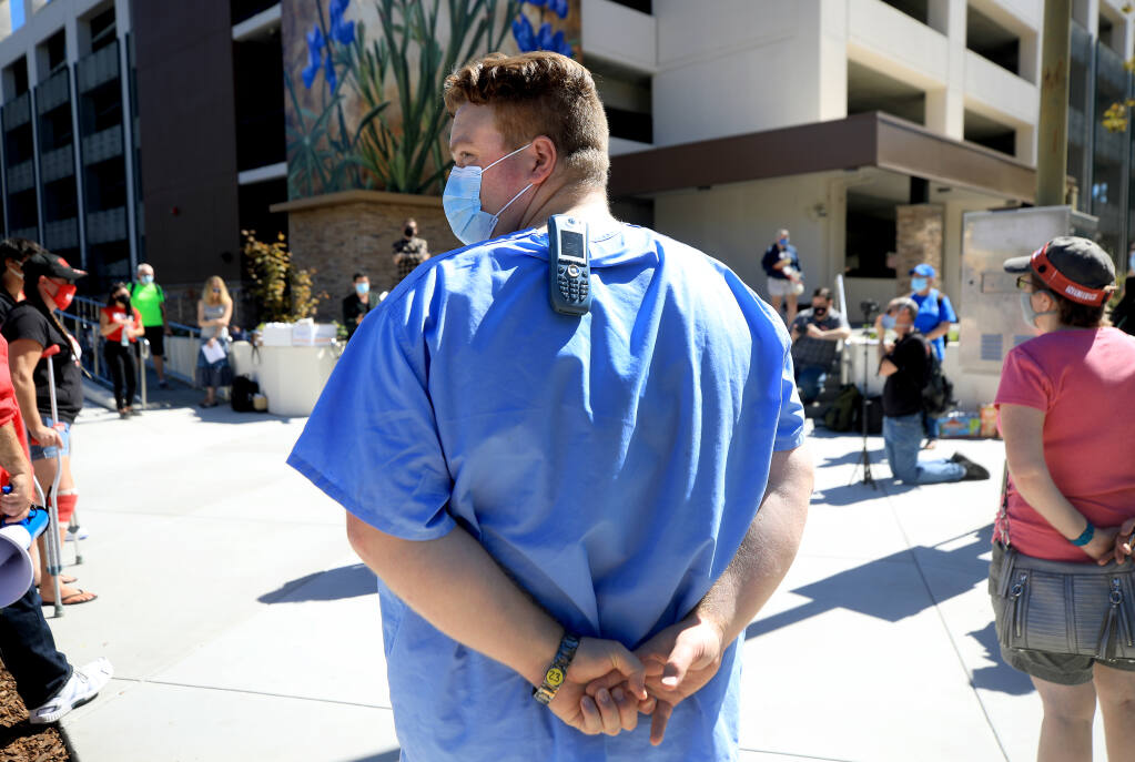 Sean Taylor, a hospital medical technician, attends a rally across the street from Santa Rosa Memorial Hospital, Wednesday, Sept. 23, 2020, in a call for hospital administration to conduct broader COVID-19 testing and ramp up infection control. (Kent Porter / The Press Democrat) 2020