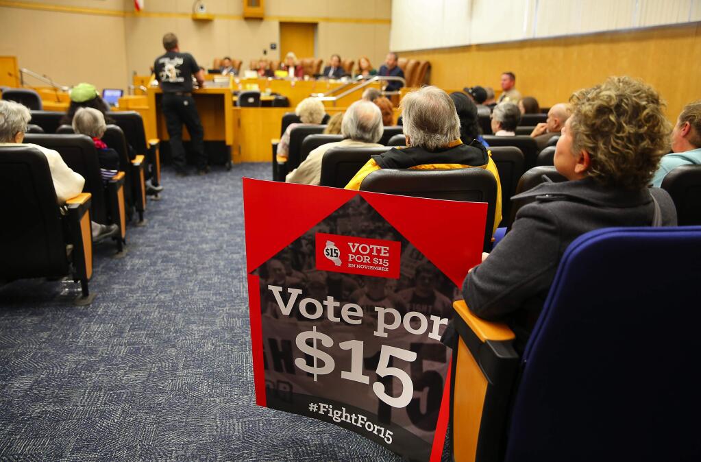 Living wage supporters wait for their item to come up on the agenda at the Sonoma County Board of Supervisors meeting, in Santa Rosa, on Tuesday, December 8, 2015. (Christopher Chung/ The Press Democrat)