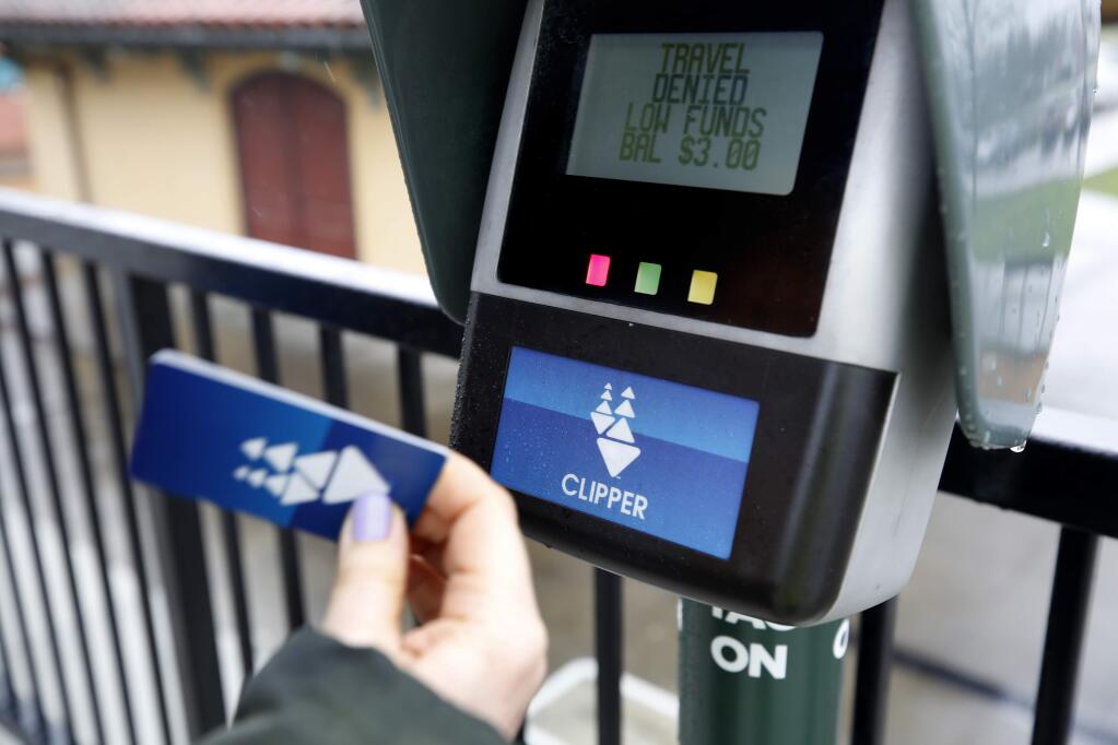 A Clipper card screen alerts a SMART passenger that their fare balance is low at the downtown station in Petaluma, California. (Beth Schlanker / The Press Democrat, 2019)