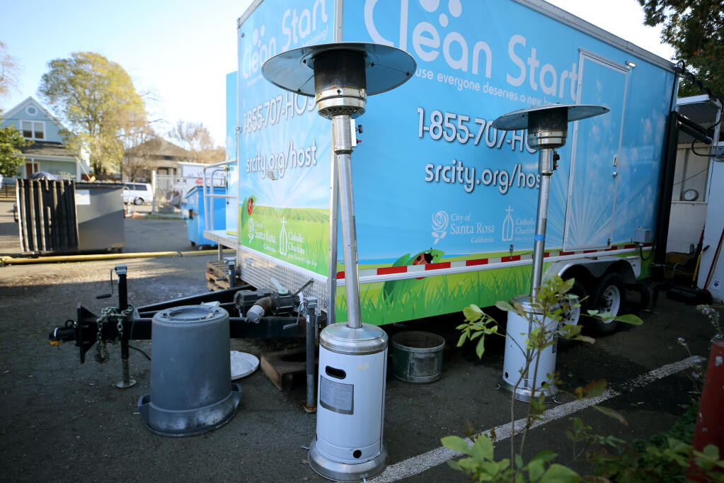 Propane heat lamps are used as part of a nighttime outdoor warming center at the St. Vincent de Paul Society in Santa Rosa, Calif., on Wednesday, February 23, 2022.(The Press Democrat)