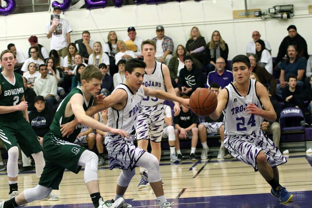 DWIGHT SUGIOKA/FOR THE ARGUS-COURIERPetaluma's Justin Wolbert swings around a pick set by teammate Austin Paretti in the Trojans' 47-36 win over Sonoma Valley.