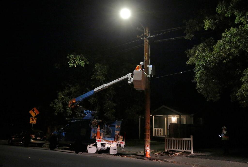 A PG&E crew works to reenergize power lines along Middle Rincon Road after the PG&E public safety power shutoff, in Santa Rosa on Thursday, Oct. 10, 2019. (ALVIN JORNADA/ PD
