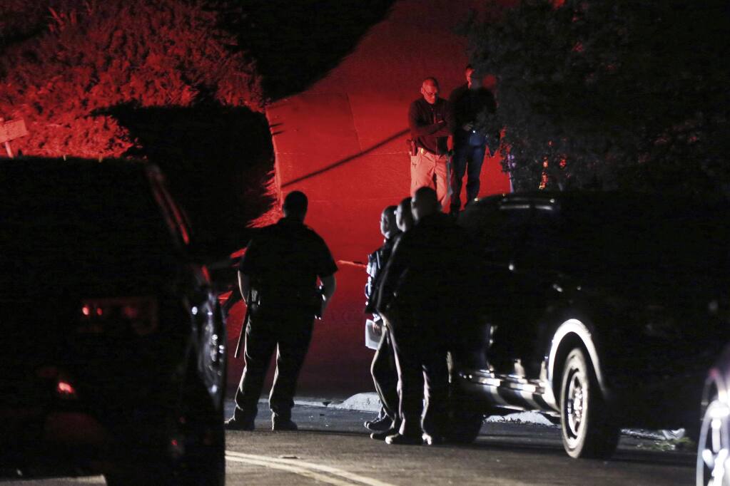 FILE - In this Thursday, Oct. 31, 2019, file photo, Contra Costa County Sheriff deputies investigate a multiple shooting on Halloween at a rental home in Orinda, Calif. Prosecutors said Monday, Nov. 18, 2019, that they won't immediately file criminal charges against five men arrested on suspicion of shooting up a San Francisco Bay Area Halloween party, killing five people. (Ray Chavez/East Bay Times via AP, File)