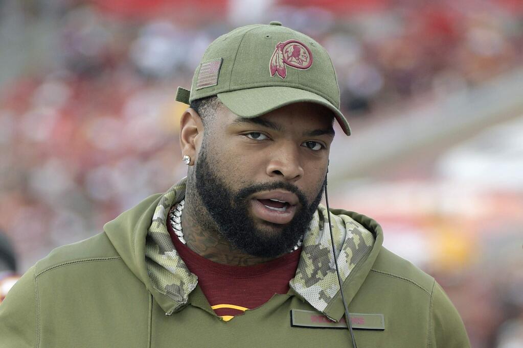 In this Nov. 11, 2018, file photo, Washington Redskins offensive tackle Trent Williams is shown on the sideline during the second half against the Tampa Bay Buccaneers, in Tampa, Fla. After sitting out last season in a dispute in Washington, seven-time Pro Bowl left tackle Williams is excited to start over in San Francisco. (AP Photo/Phelan M. Ebenhack, File)