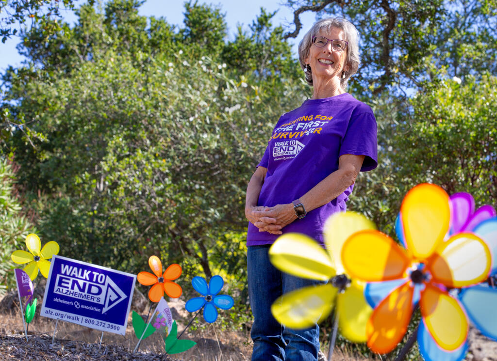 Patti Wick, who serves on the local committee to organize the Walk to End Alzheimer's, stands Saturday, Sept. 26, 2020, among Promise Garden flowers that are carried by walk participants, with each color representing how their lives have been touched by Alzheimer's disease.